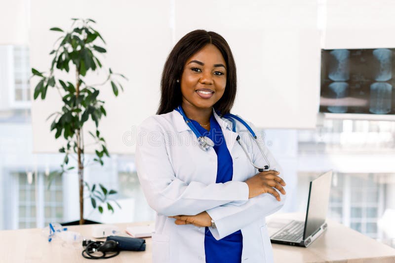 Portrait Of Female Doctor In Doctor`s Office. Successful African woman doctor standing in office