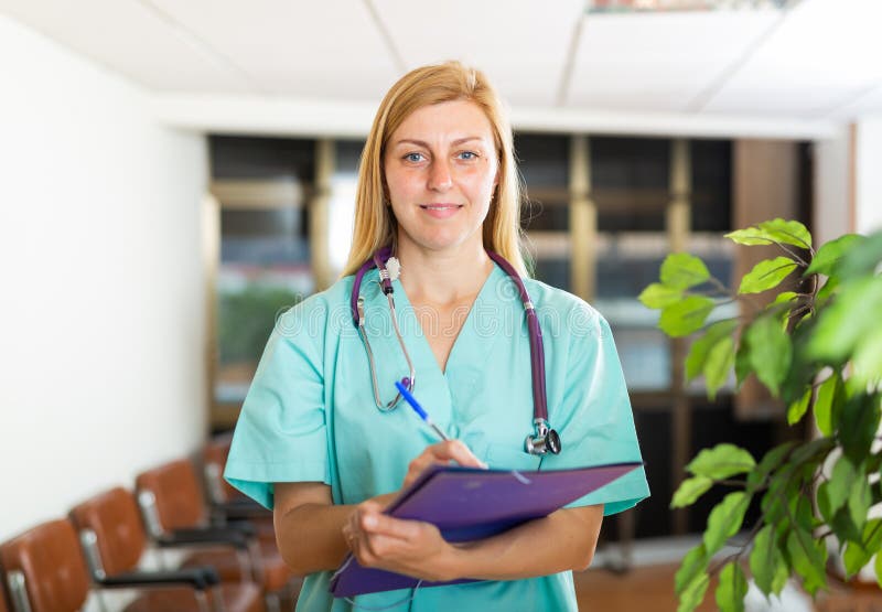Portrait of Female Doctor Wearing Uniform and Stethoscope with Folder
