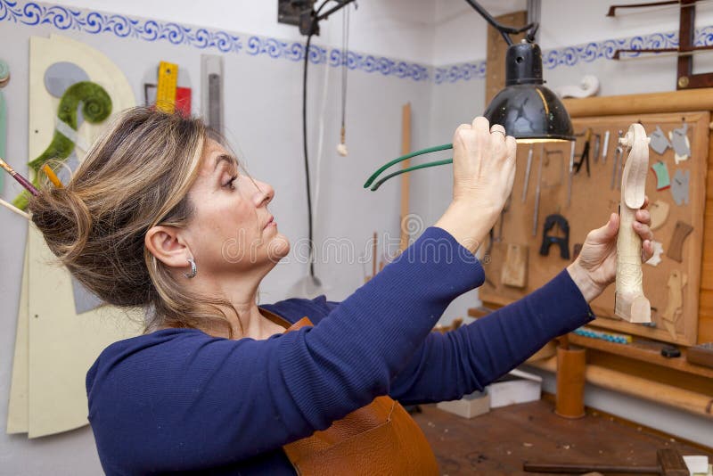 Portrait of female mature violin maker