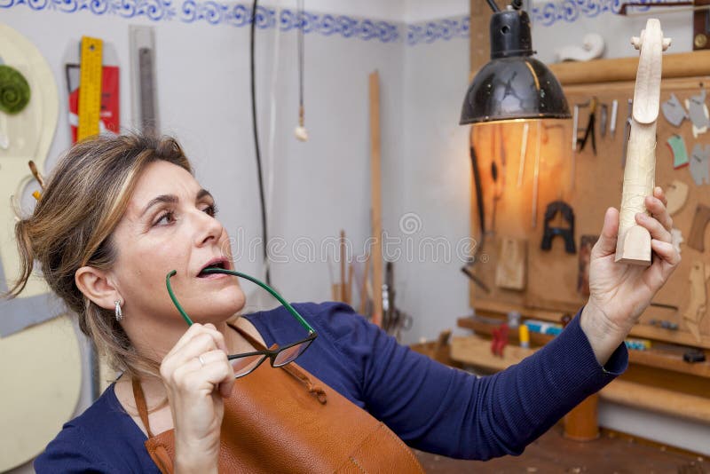 Portrait of female mature violin maker