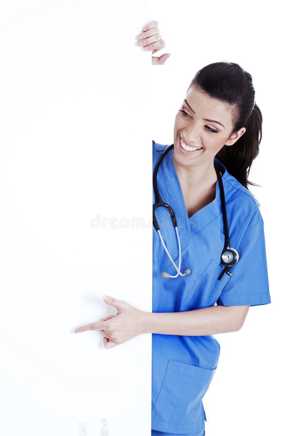 Portrait of female nurse standing behind board