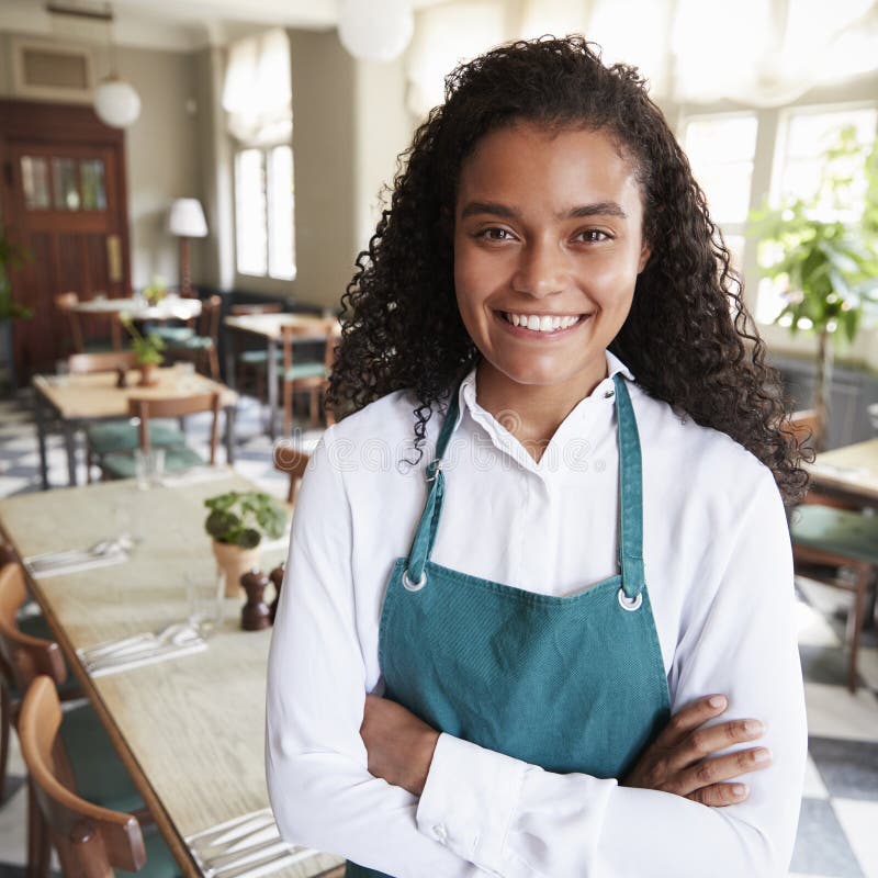 Portrait of Female Restaurant Manager in Empty Dining Room Stock Image
