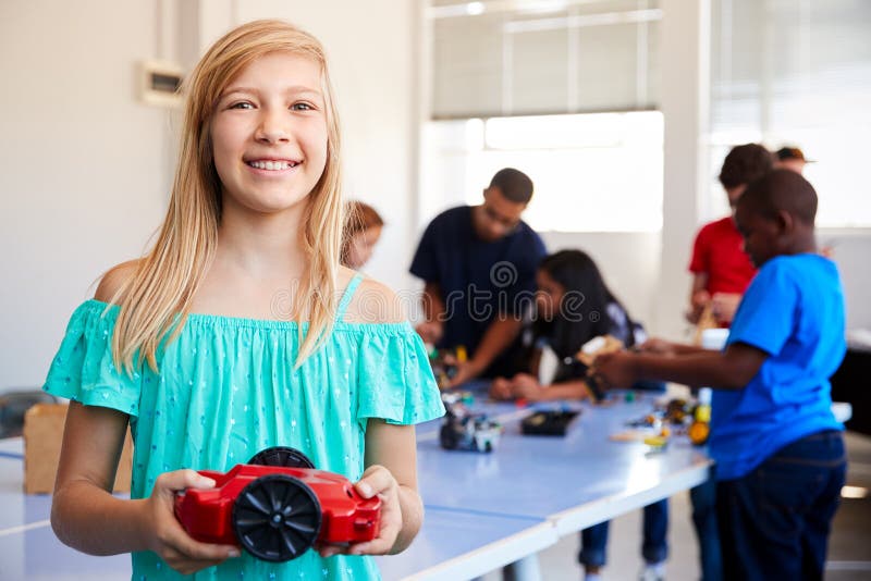 Portrait Of Female Student Building Robot Vehicle In After School Computer Coding Class stock image