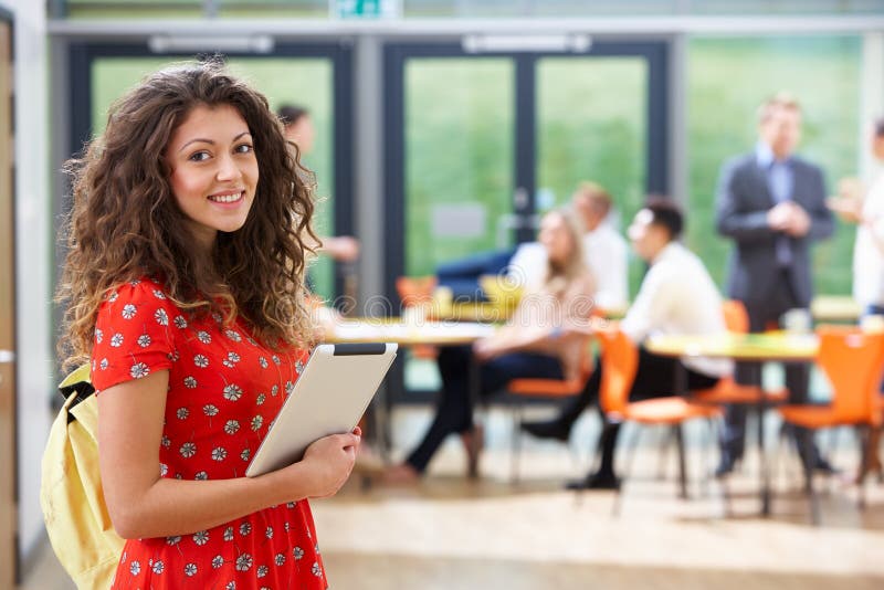 Portrait Of Female Student In Classroom With Digital Tablet