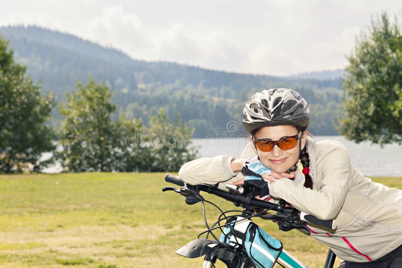 Portrait of female tourist cyclist posing on the background of stock photo Portrait of female tourist cyclist posing on the background of stock photo