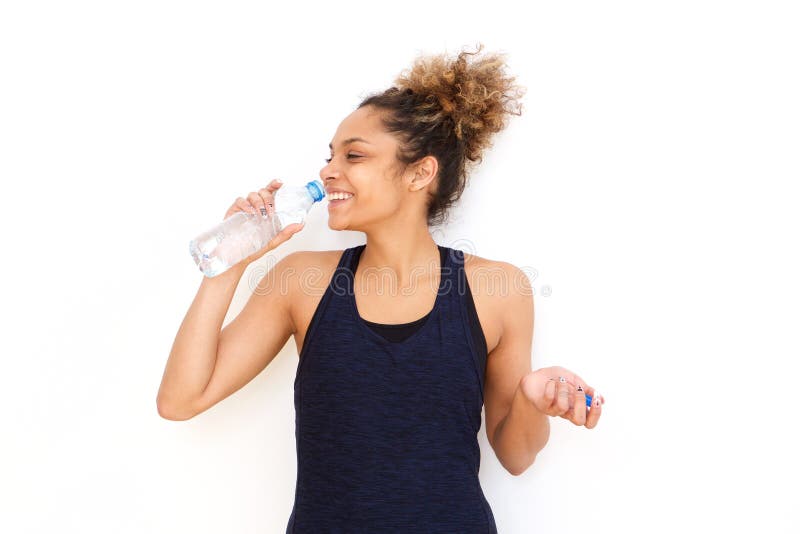 Fitness woman drinking water from bottle against white background