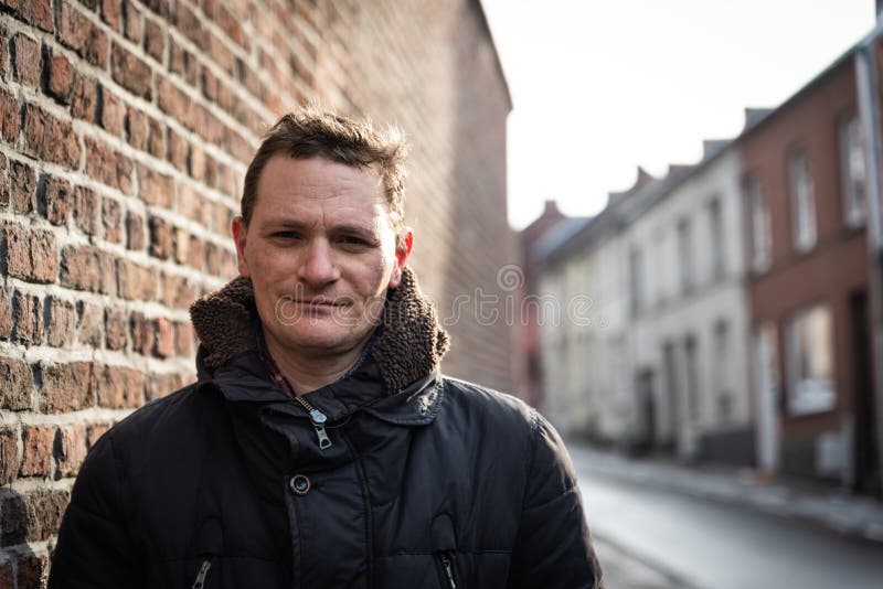 Portrait of a forty year old man posing in the streets of old town in witer