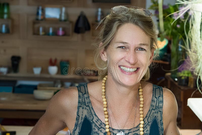 Portrait Of A French Blonde Mature Woman Smiling At Her Store