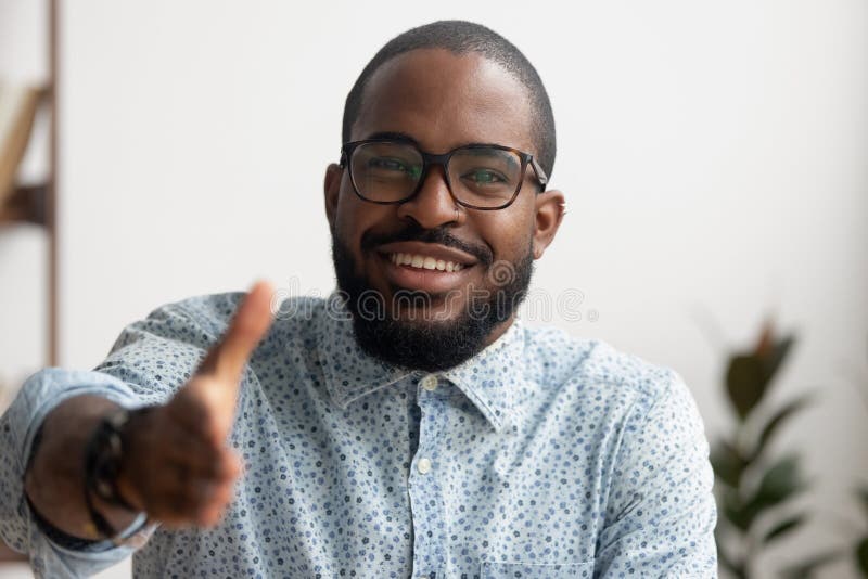 Portrait of friendly smiling African businessman offering hand for greeting royalty free stock photography Portrait of friendly smiling African businessman offering hand for greeting royalty free stock photography