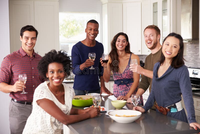 Portrait of Friends Enjoying Pre Dinner Drinks at Home Stock Photo