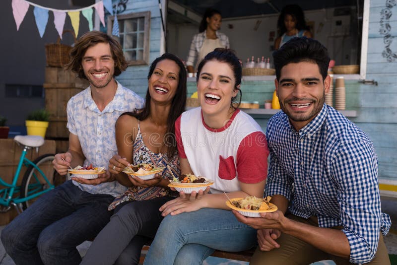 Portrait of friends sitting with snacks stock photos