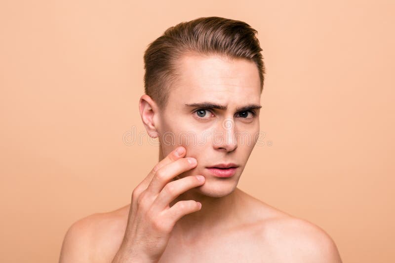 Portrait of frustrated, naked brown-haired man looking for acne stock image Portrait of frustrated, naked brown-haired man looking for acne stock image