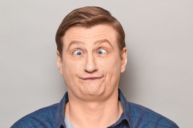 portrait-funny-confused-man-crossed-eyes-studio-close-up-blond-mature-making-crazy-goofy-face-expressing-puzzlement-209431016.jpg