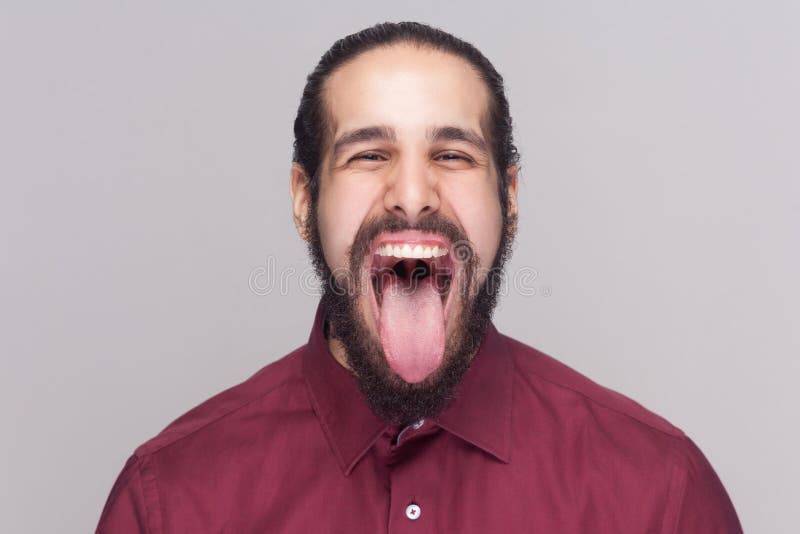Portrait of funny crazy handsome man with dark hair and beard in royalty free stock images