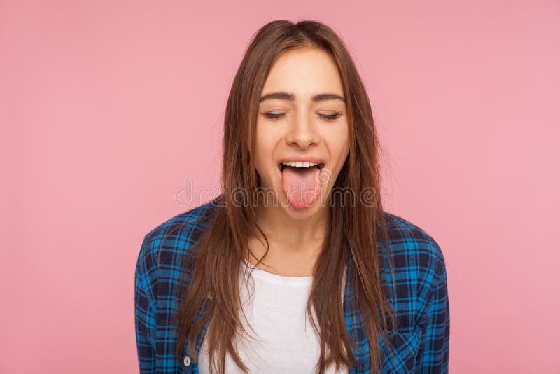 Portrait of funny disobedient girl in checkered shirt keeping eyes closed and sticking out her tongue stock photos Portrait of funny disobedient girl in checkered shirt keeping eyes closed and sticking out her tongue stock photos