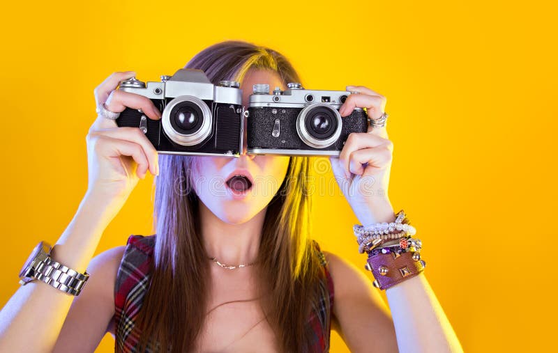 Portrait of funny girl with two cameras