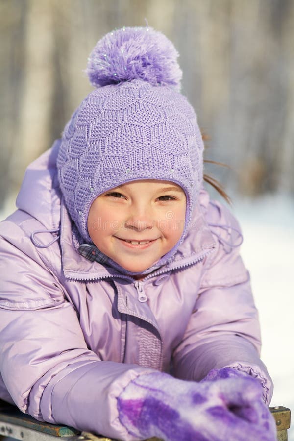 Portrait of a funny little girl on a walk in the winter. child outdoors.