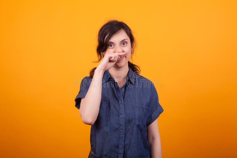 Portrait of funny young woman scratching her nose after using cosmetics