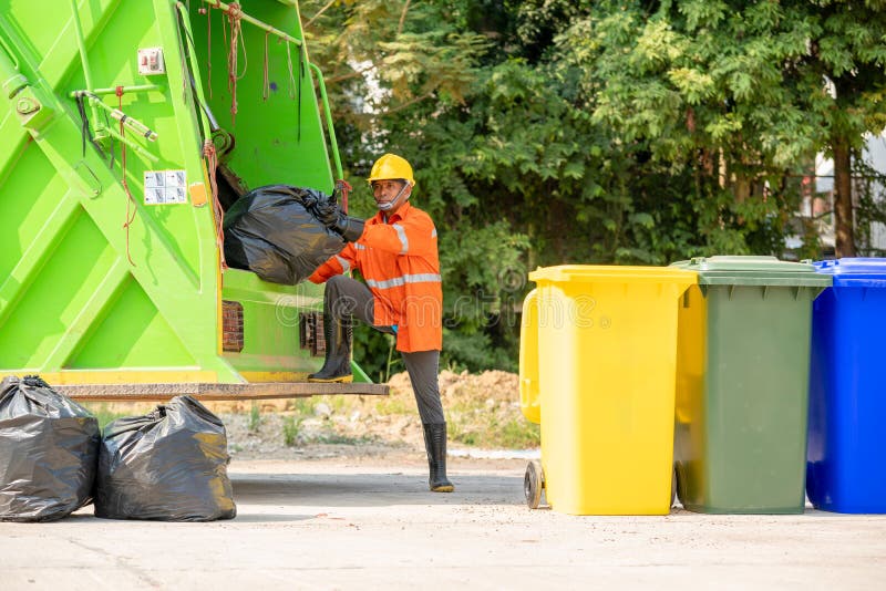 Portrait of Garbage Collector with Truck Loading Waste. Stock Image