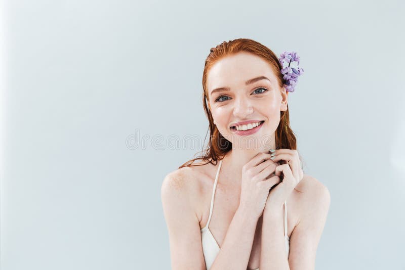 Portrait of a ginger woman with flower in her hair