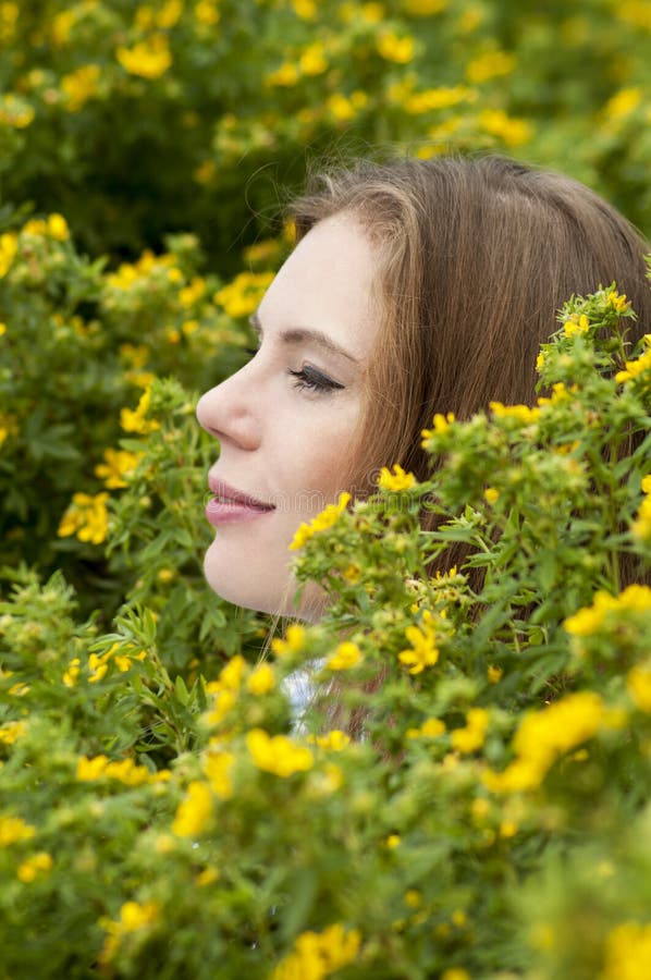 Portrait Of Girl On A Background Of Yellow Flowers. Stock Photo - Image ...