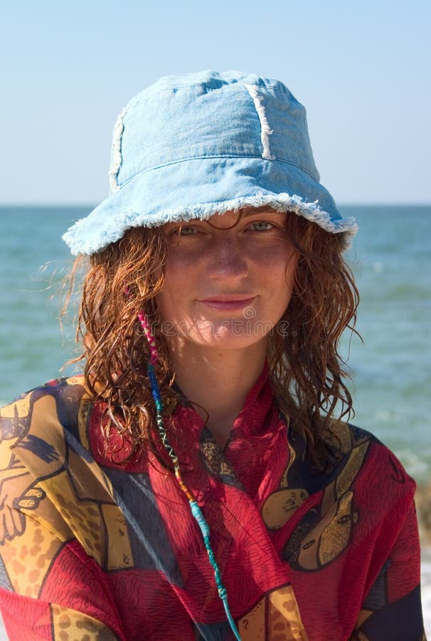 Portrait of girl in blue panama at seaside