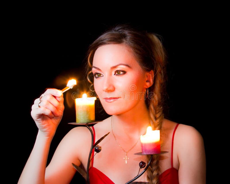 Portrait of a girl candle lights a match stock photography
