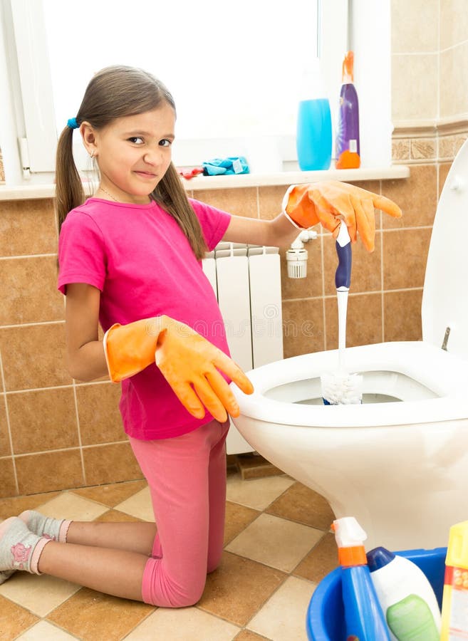 Portrait Of Girl Cleaning  Toilet  With Disgust Stock Photo 