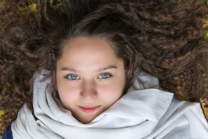Girl with Curly Hair Lying on the Ground Stock Photo - Image of health, cute:  101151976