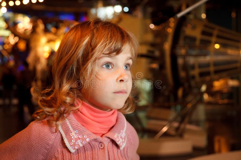 Portrait of girl in dark room of museum space