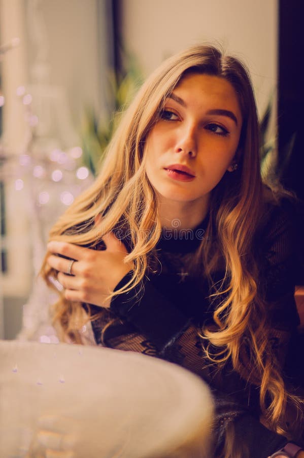 Portrait of a Girl. Elegant Lady in a Black Dress in a Restaurant Alone ...