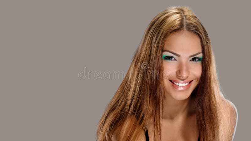 Portrait of bright smiling girl with long hair