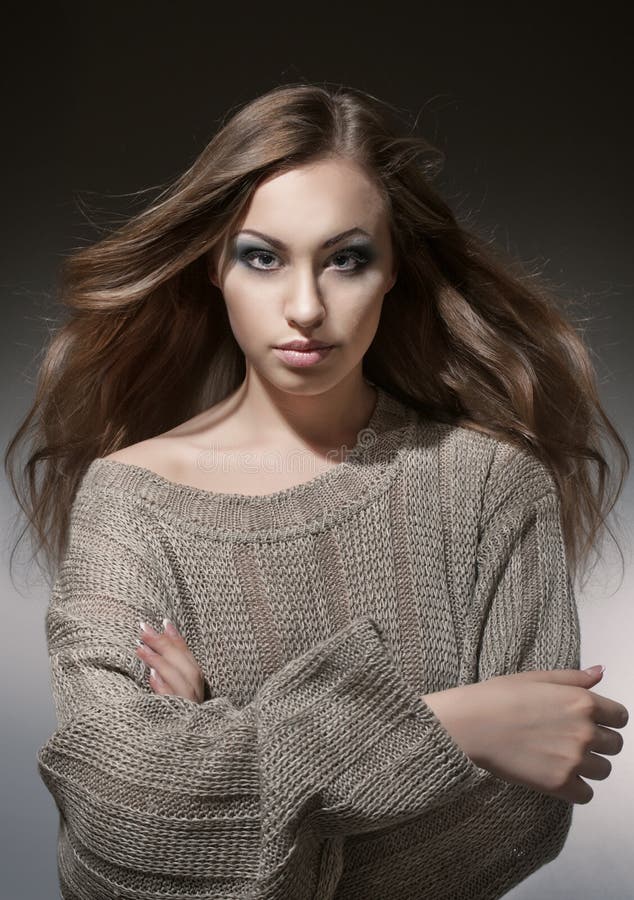 Portrait of a girl in a gray knitted sweater