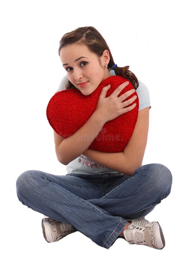 Portrait of a girl hugging a big red plush heart