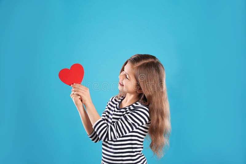Portrait Of Caucasian Girl With Paper Doll High-Res Stock 