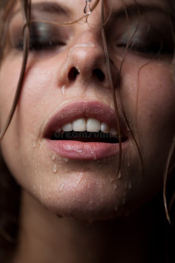 Portrait of a girl s face which water flows