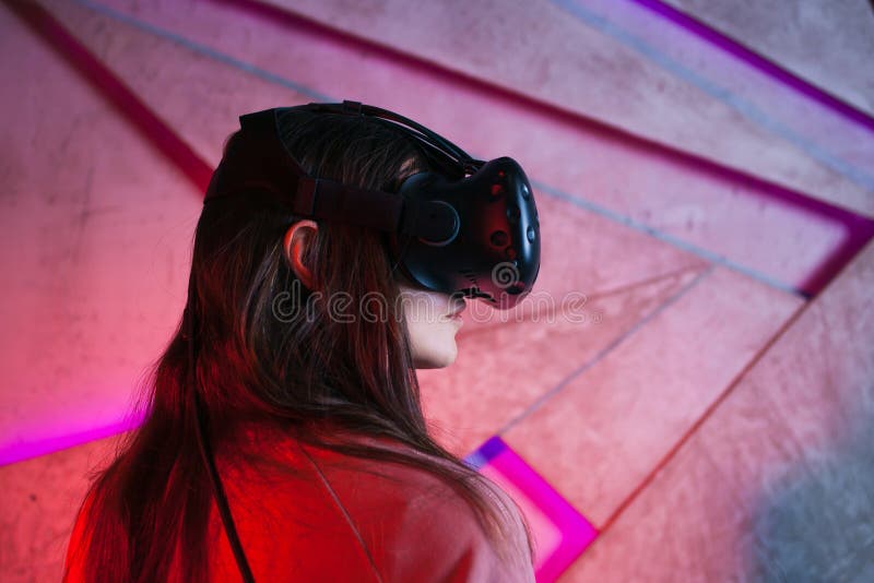 of a Girl, a Woman in Virtual Reality Glasses, Against the Background a Wall, by Neon. Stock Image - Image of device, female: 163438113