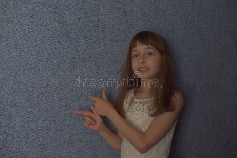 Portrait. Girl 9 Years Old on a Background of Blue Wallpaper at Home