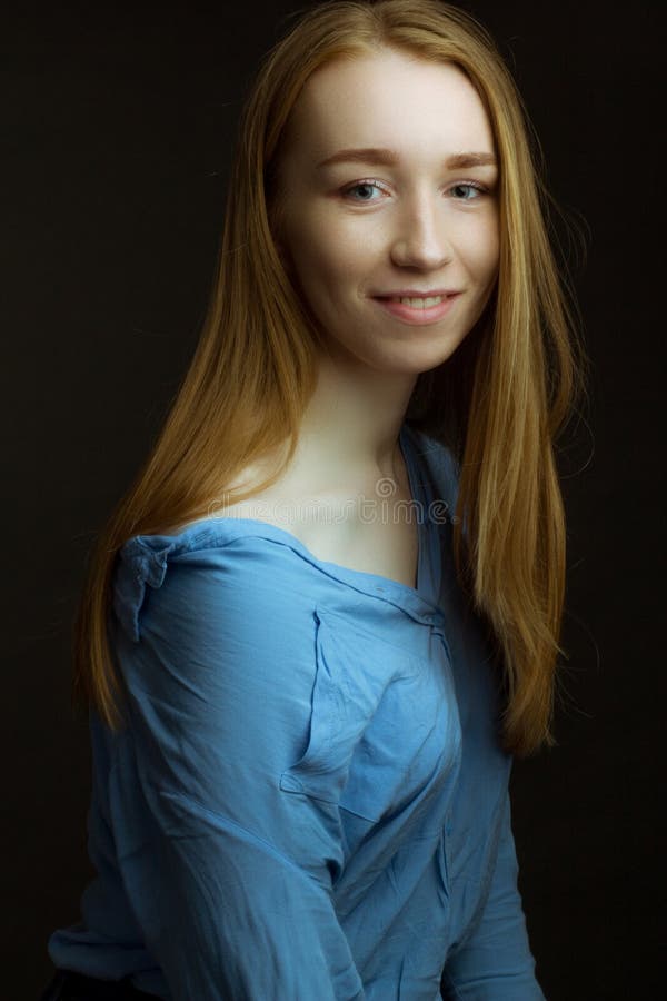 Portrait Of Girl Young Woman With Long Blonde Hair Wearing A Blue Shirt