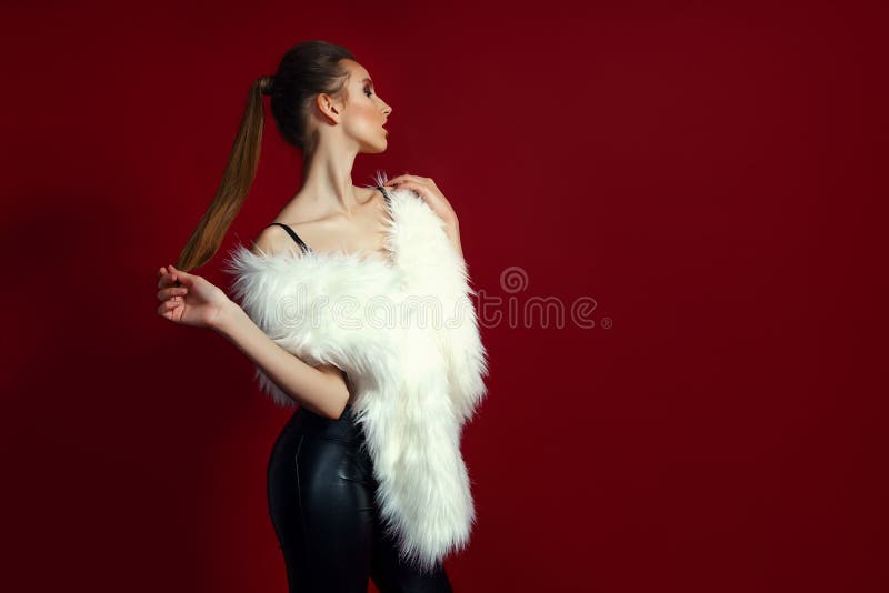 Portrait of glam girl in white fur on red background. Fashion photo stock photography Portrait of glam girl in white fur on red background. Fashion photo stock photography
