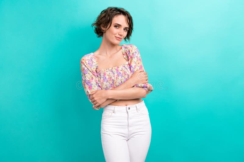 Portrait of good mood gorgeous girl with bob hairstyle dressed flower print blouse cuddle herself isolated on teal color