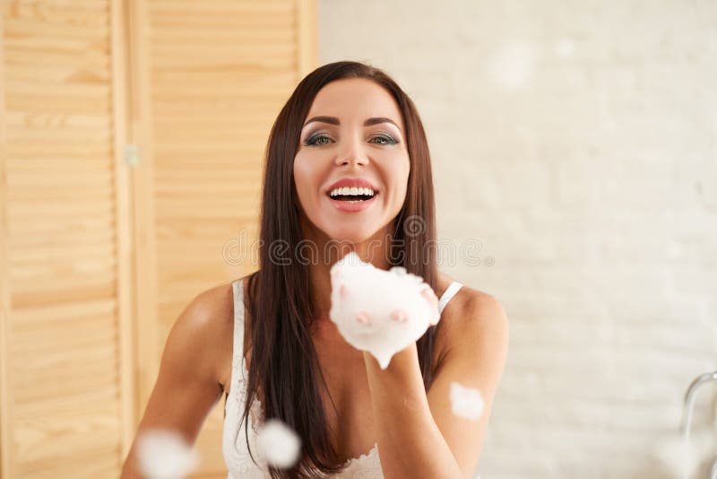 Portrait Gorgeous Female Takes A Bath Plays With Soapy Foam Blowing Foam From Hands Stock