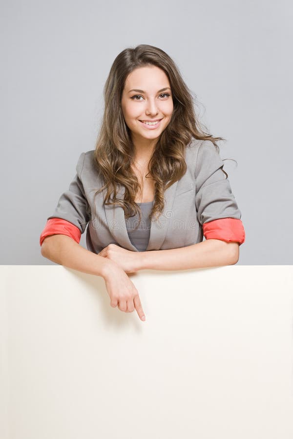 Young businesswoman with large blank banner. Portrait of gorgeous young businesswoman with large blank banner royalty free stock photos Young businesswoman with large blank banner. Portrait of gorgeous young businesswoman with large blank banner royalty free stock photos
