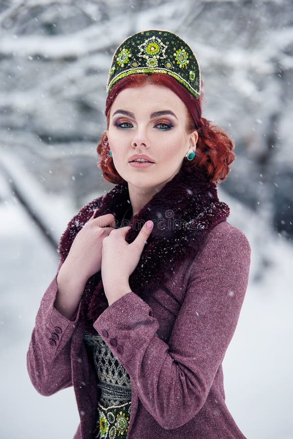 Portrait of a gorgeous young woman in russian style dress on a strong frost in a winter snowy day. Russian model girl. stock images Portrait of a gorgeous young woman in russian style dress on a strong frost in a winter snowy day. Russian model girl. stock images