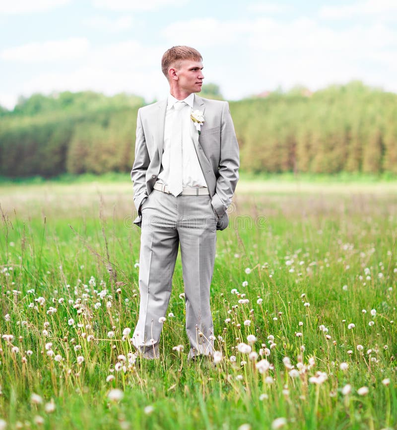 Portrait of the groom outdoors on their wedding day