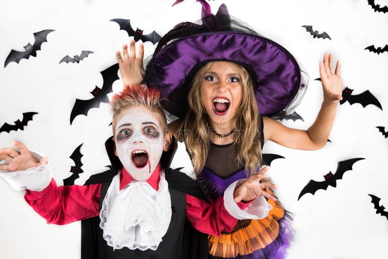 Halloween kids, Happy scary girl and boy dressed up in halloween costumes of witch, sorcerer and vampire Dracula for pumpkin patch