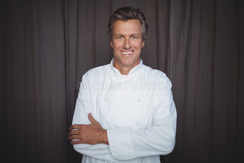 Portrait of handsome chef standing with arms crossed royalty free stock photography Portrait of handsome chef standing with arms crossed royalty free stock photography