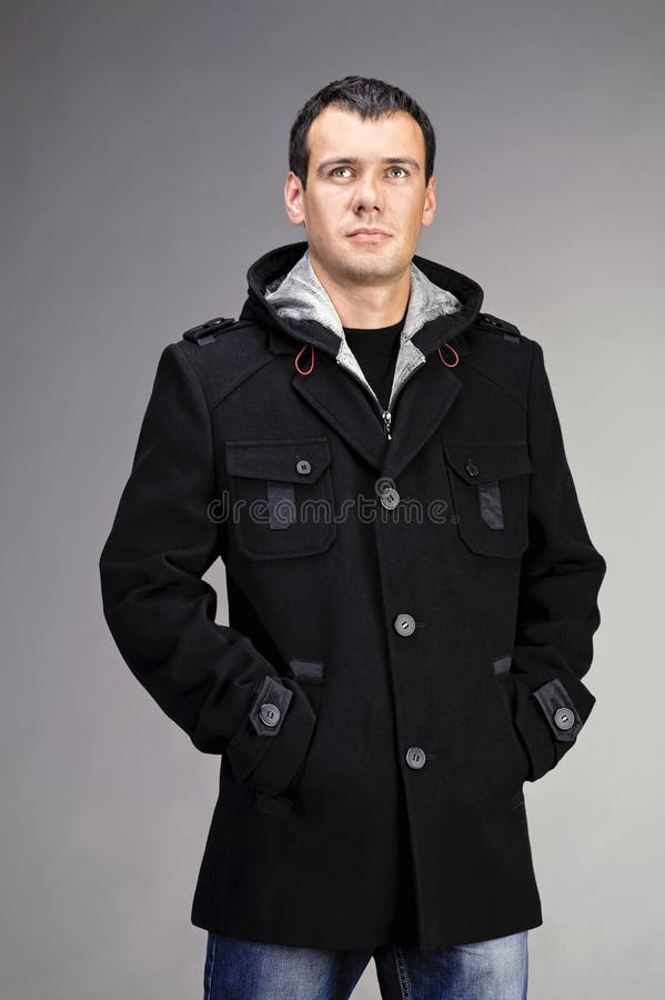 Portrait of handsome man in coat. Over gray backgroung