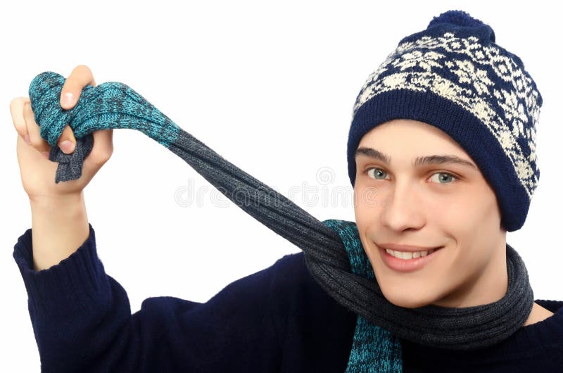 Portrait of a handsome man dressed for a cold winter. Man in sweater with hat and scarf.