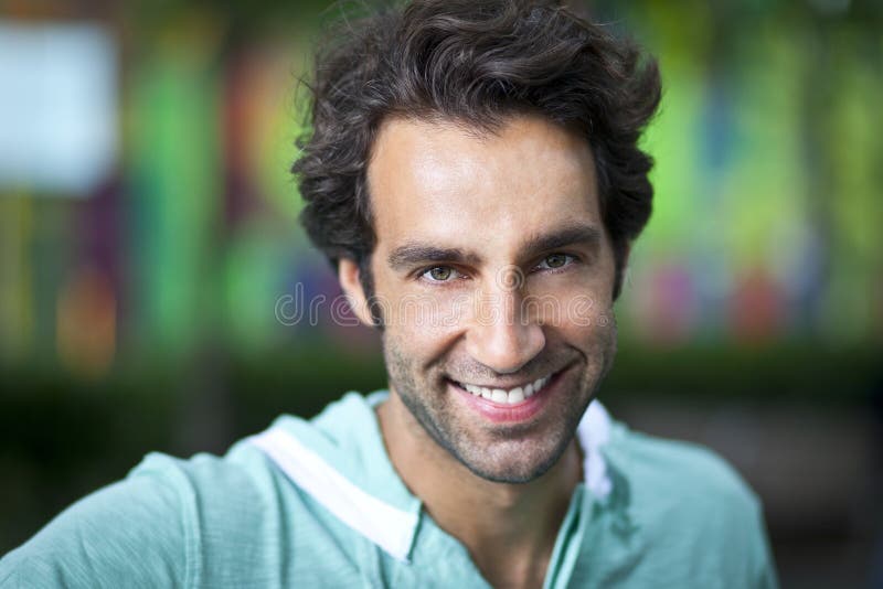 Portrait Of A Handsome Spanish Man Smiling At The Camera